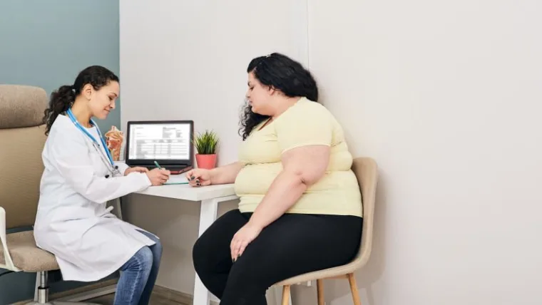 Woman visits nutritionist for treatment obesity